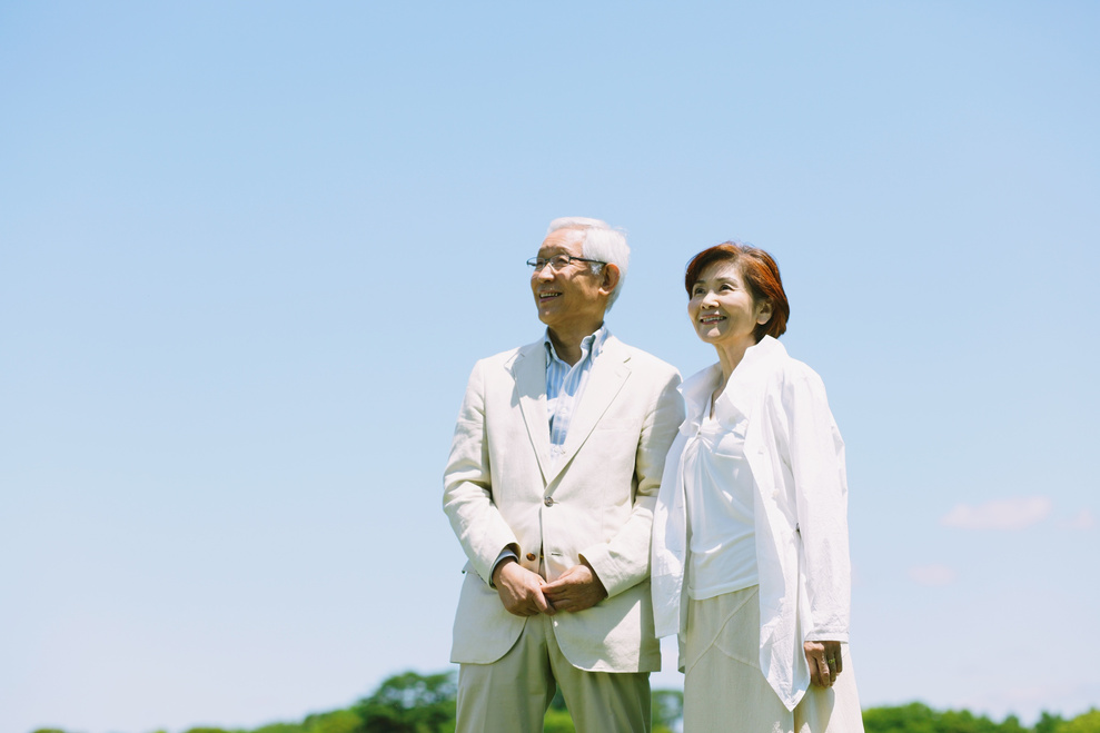 Elderly Japanese Couple Smiling in a Sunny Field